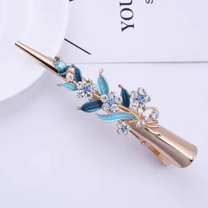 Elegant gold alloy hair clip with blue enamel flowers and sparkling rhinestones for women.