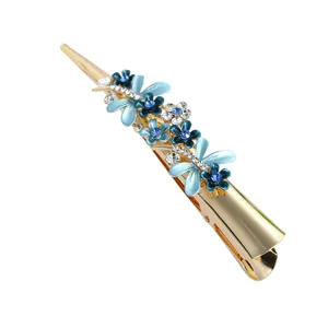 Elegant gold metal hair clip with blue enamel flowers and sparkling rhinestones for women.
