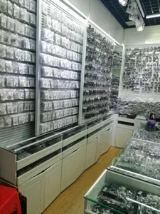 Wholesale jewelry showroom display wall with organized packaged accessories and display counters.
