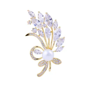 Elegant gold-tone crystal flower brooch with central pearl, perfect for suit and formal wear.