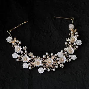 Elegante bruids haarwijnstok met witte bloemen, parels en strass voor huwelijksstyling.