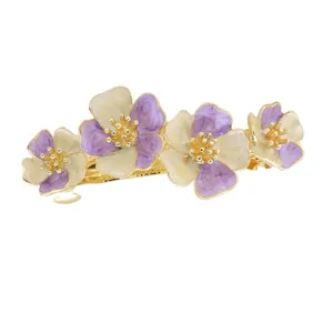 Elegant spring floral hair clip with purple and white enamel flowers and gold tone metal barrette.
