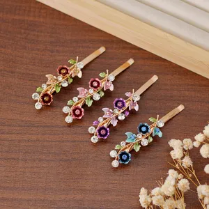 Vintage enameled floral hair clips with sparkling rhinestones, elegant side bobby pins for women.