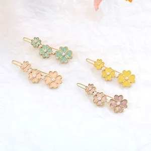 Sweet floral hair clips set with enamel and pearl details, delicate side fringe clips.