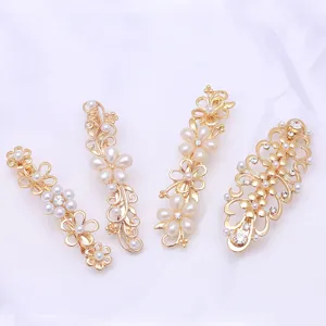 Gold floral hair clips set featuring delicate pearls and sparkling rhinestones for elegant styling.
