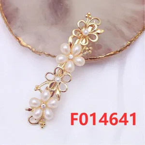 Detailed closeup of exquisite gold alloy hair clip featuring floral pearl details for styling.