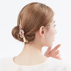 Gold alloy hair claw clip with pink floral rhinestones elegant hair accessory for women.