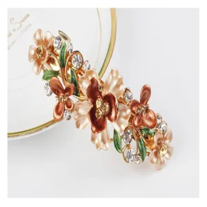 Exquisite alloy enamel floral rhinestone hair clip, elegant gold tone spring hairpin.
