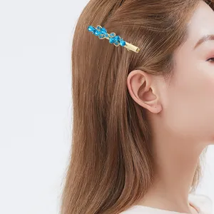 Elegant blue rhinestone hair clip for women, gold tone side duckbill bobby pin fashion accessory.