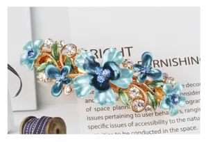 Close-up detail of blue enamel butterfly and flower hair clip sparkling rhinestones alloy.