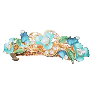 Exquisite detail of blue enameled flower hair clip, sparkling rhinestones and pearl accent.