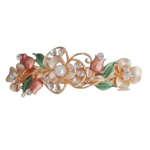 Detailed view of gold alloy rhinestone enamel flower hair clip, shiny crystal butterfly design.