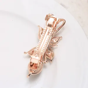 Rose gold tone metal hair barrette spring clip with floral design, elegant hair accessory.