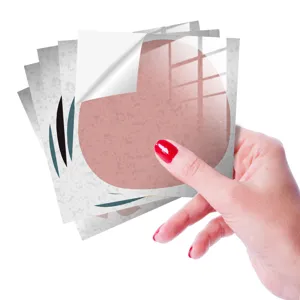 Close-up detail of retro self-adhesive tile stickers showing peeling backing paper texture.
