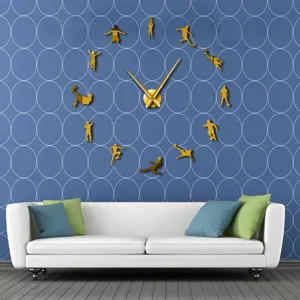 Detailed scene of a golden 3d acrylic mirror football wall clock mounted in living room.