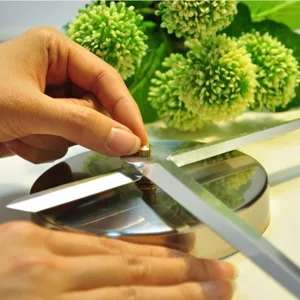 Close-up view of DIY wall clock movement and elegant silver metal clock hands detail.