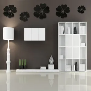 Living room interior scene showing black 3D acrylic mirror flower wall stickers mounted.