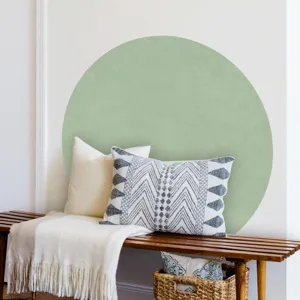 Detail view of a boho round wall sticker in green, styled on a wooden bench with pillows.