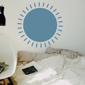 Boho blue sun wall sticker detail in cozy bedroom setting, aesthetic home decor sticker for wall.