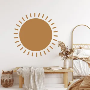 Detail view of boho sun wall sticker in modern room decor, warm aesthetic interior style.