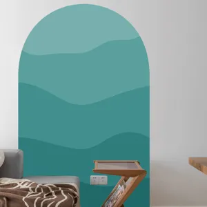 Close-up detail of the boho arch wall sticker featuring layered teal waves in a modern room.