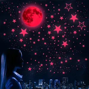 Detail view of luminous moon and star wall stickers glowing in dark for kids bedroom decor.