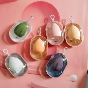 Capsule makeup sponge storage box with portable hanging rope, dust-proof clear case for beauty.