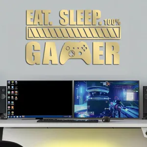 Detail view of gold acrylic gaming wall sticker mounted above computer desk for room decor.