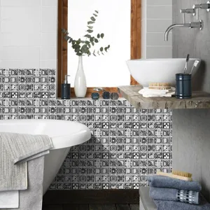 Bathroom tile stickers detail showing black and white geometric mosaic wall decor design.