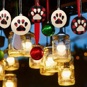 Christmas wooden paw print hanging ornaments, buffalo plaid holiday tree decor details.