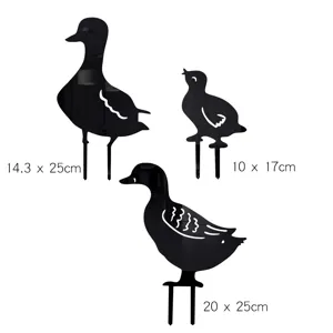 Black acrylic duck family garden stakes detail, silhouette yard art decor for outdoor lawn.