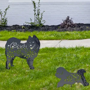 Detailed view of metal dog silhouette garden stakes with hollow floral art for outdoor yard decor.