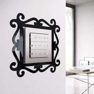 Detail view of the decorative black acrylic switch frame wall sticker in a modern interior setting.