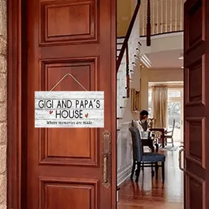 Wooden hanging sign detail showing decorative typography and text on a rustic wooden door.