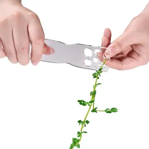 Close-up of clear acrylic herb stripper tool demonstrating leaf removal on fresh green stem.