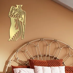 Close-up detail of the golden abstract female body acrylic mirror wall sticker in modern bedroom.