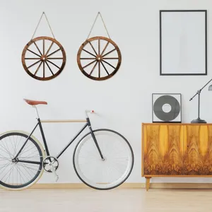 Rustic wooden wagon wheel wall decor, vintage hanging art for home interior living room.
