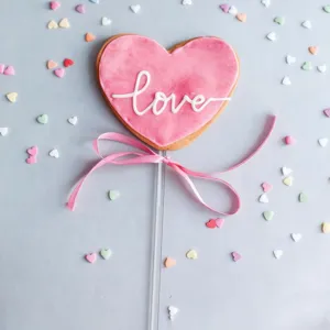 Heart-shaped cake decoration stick with pink icing and bow for party dessert DIY baking