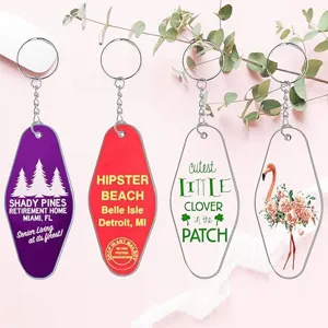 Close-up details of vintage acrylic motel keychains featuring colorful prints, clear shape and metal.