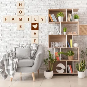Wooden square wall decor pieces displayed in a modern living room crossword arrangement.