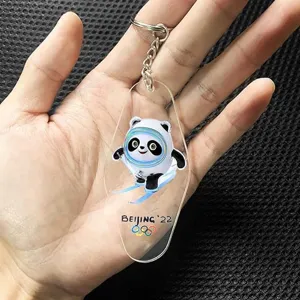 Acrylic keychain pendant featuring transparent diamond shape with printed winter sports design.