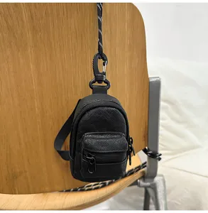 Mini mochila negra para mujer y hombre, monedero y portatarjetas para auriculares con cordón.