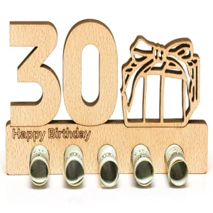 Wooden 30th birthday money gift holder detail showing cut-out numbers and rolled paper cash.