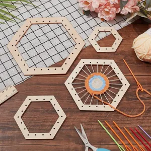 Wooden hexagon weaving loom set detail showing frames, yarn and tools on a rustic wooden table.