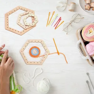 Detailed view of DIY wooden hexagon weaving loom set with colorful yarn and plastic needles.