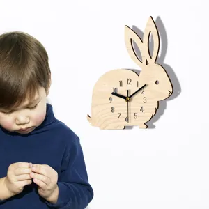 Wooden rabbit wall clock detail showing cute animal shape and clear clock numbers for kids room.