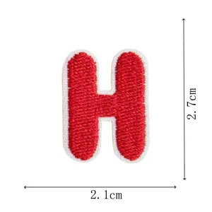 Close-up detail of letter H embroidered patch, red and white design, mini DIY accessory.