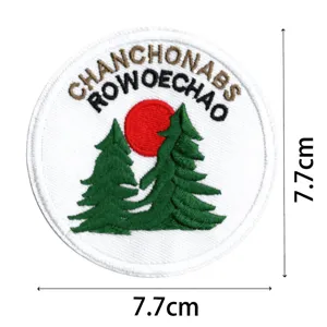 Embroidered patch detail featuring pine trees and sun design, perfect for jackets.