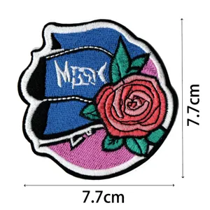 Embroidered patch detail showing blue guitar shape with pink rose, size 7.7cm for jackets.