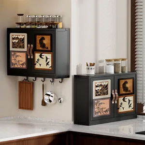 Black wall-mounted kitchen storage cabinet with decorative panels and spice jars set.